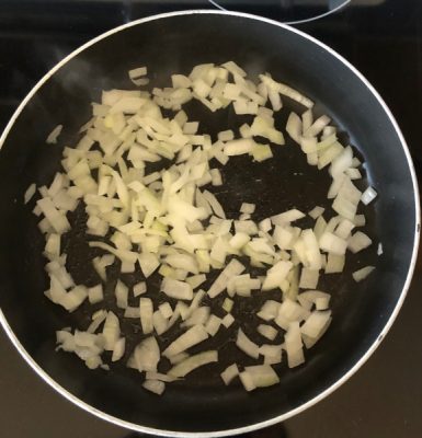 Onions being cooked in a pan