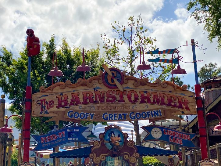 Image of the entrance to the Barnstormer staring the Great Goofini. The sign is done in a circus style. 