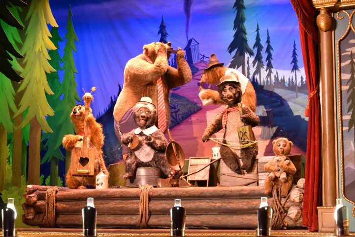 Image from the inside of Country Bear Jamboree. Five animatronic bears on a stage play various homemade instruments.