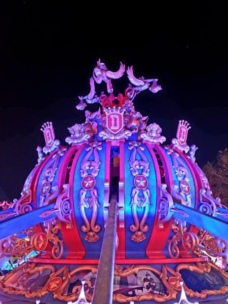 The center section of Dumbo the FLying Elephant that the ride rotates around, illuminated at night. 