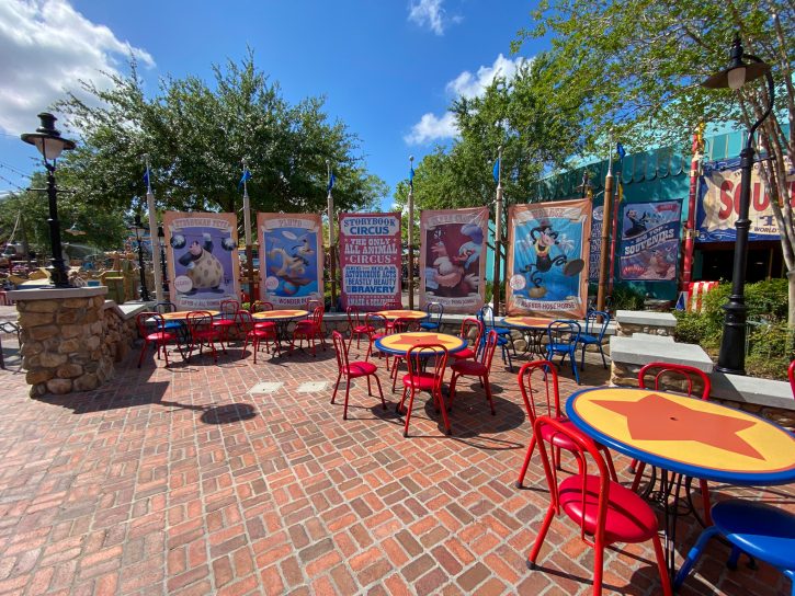 The seating area outside of Pete's Silly Sideshow, which is surrounded by circus posters for the characters that can be met inside. 