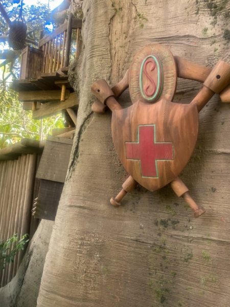 The family crest on the side of the tree in the Swiss Family Robinson Treehouse. 