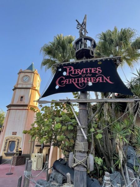 The sign for Pirates of the Caribbean that looks like the mast and sails of a pirate ship. 