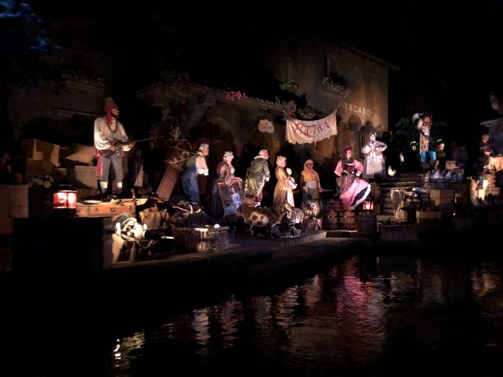 An auction scene of Animatronic pirates selling pillaged goods and townspeople from the Pirates of the Caribbean ride. 